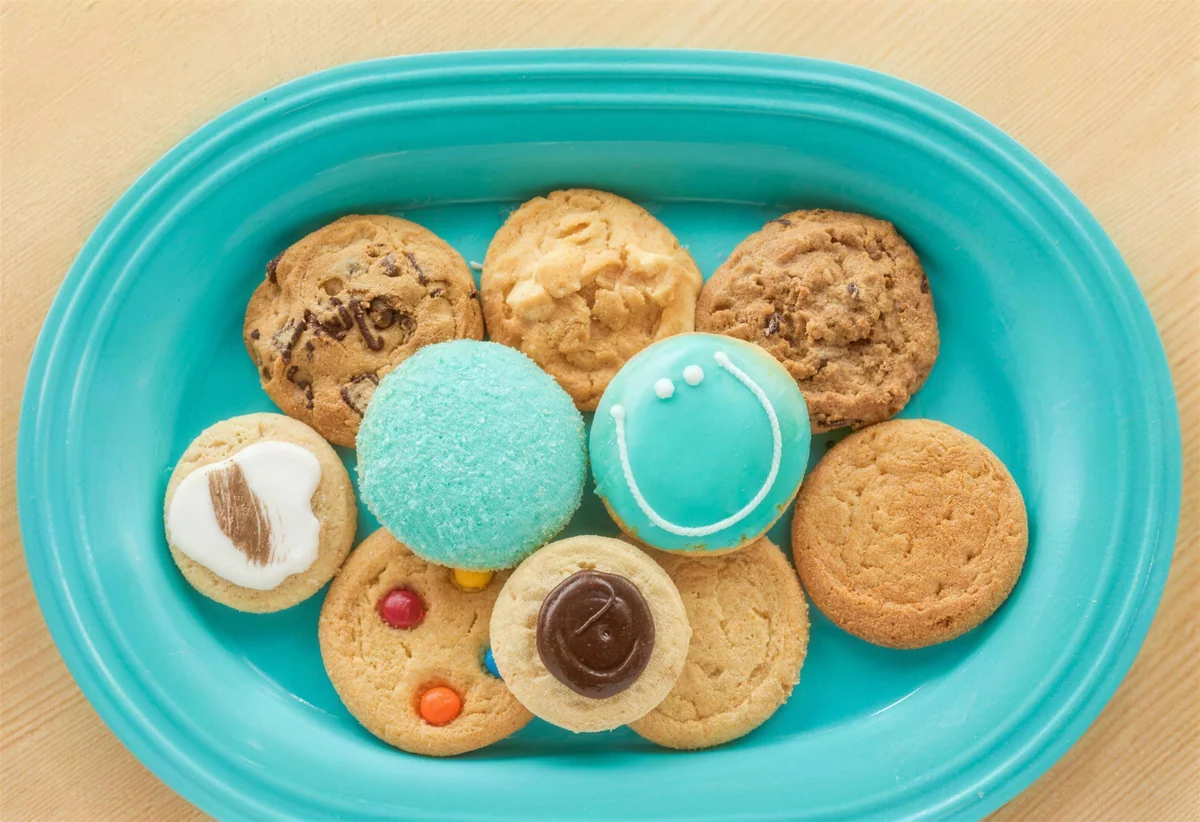 An assortment of gourmet cookies on a blue plate