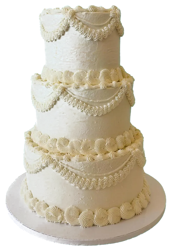 A vintage-piped ivory cake with pearl borders