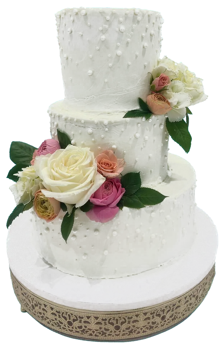 A white cake with roses and ranunculus on an ivory stand