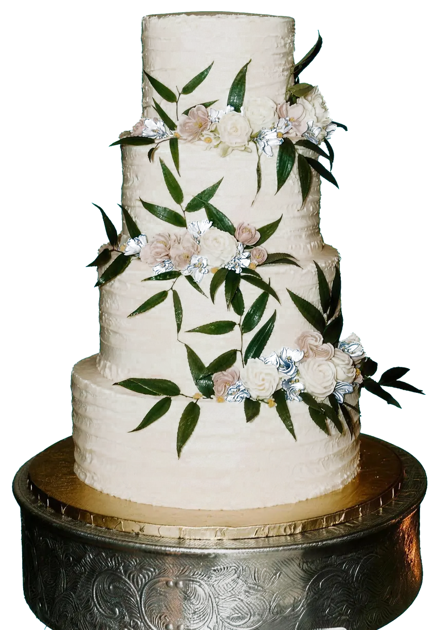 A four-tier textured buttercream cake with greenery and blush roses on a silver stand